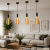 Minimalistyczna lampa wisząca E27 z dekoracyjną żarówką filamentową XXL – idealna do wnętrz loft, industrial i retro.